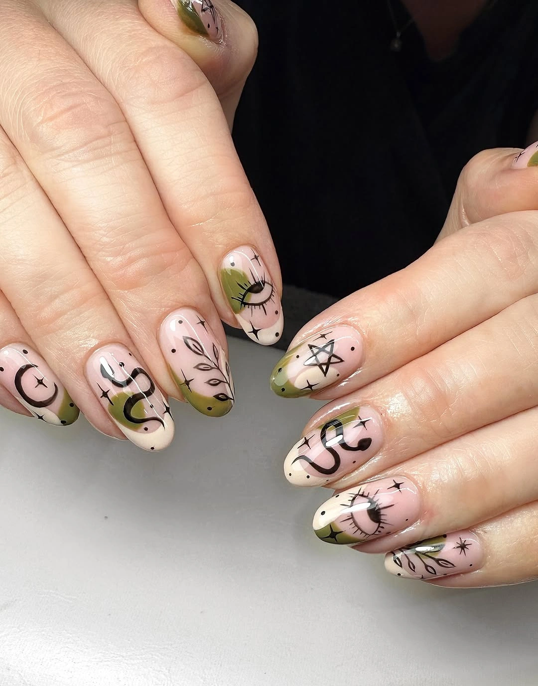 Light almond nails with abstract black doodle linework
