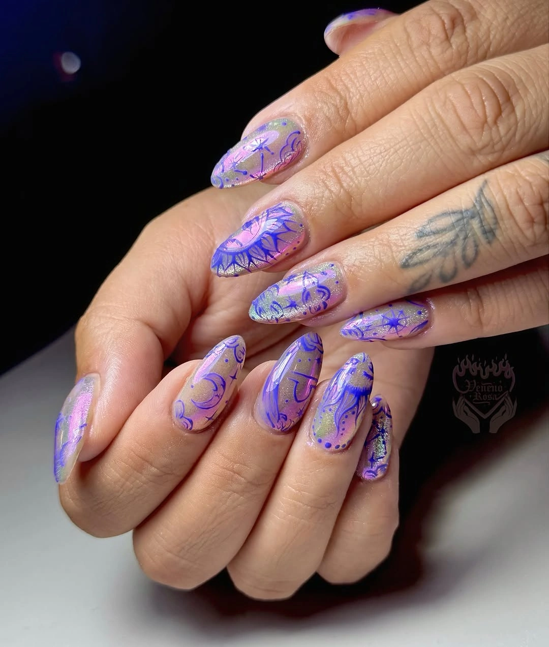 Long lavender nails with purple swirls and reflective accents
