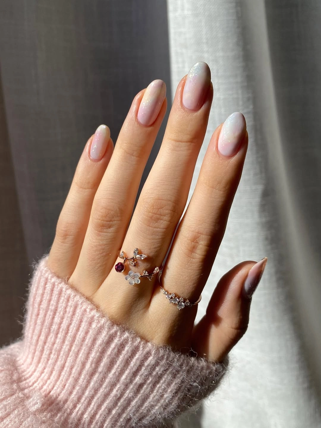 Long sheer nude nails with thin white graphic French edges