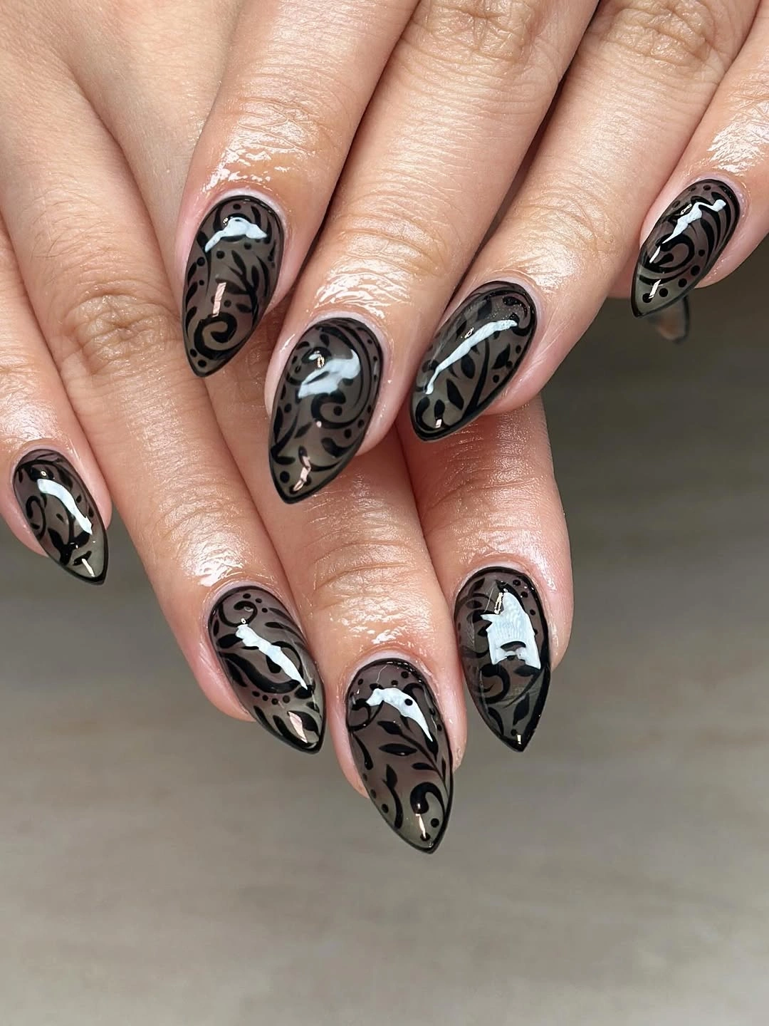Black almond nails with flowing white smoky marble swirls