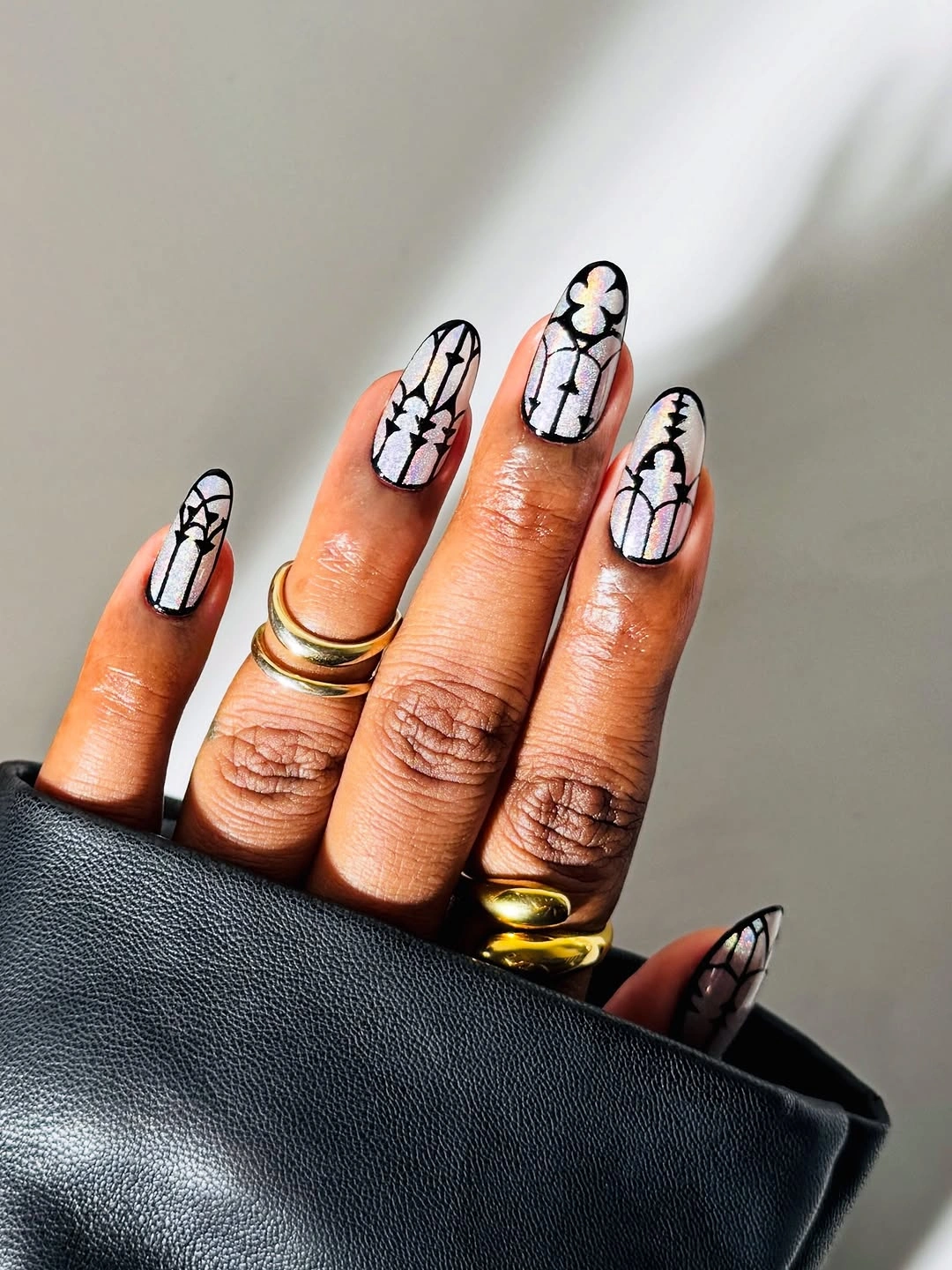 Long nude nails with white black outlined graphic details