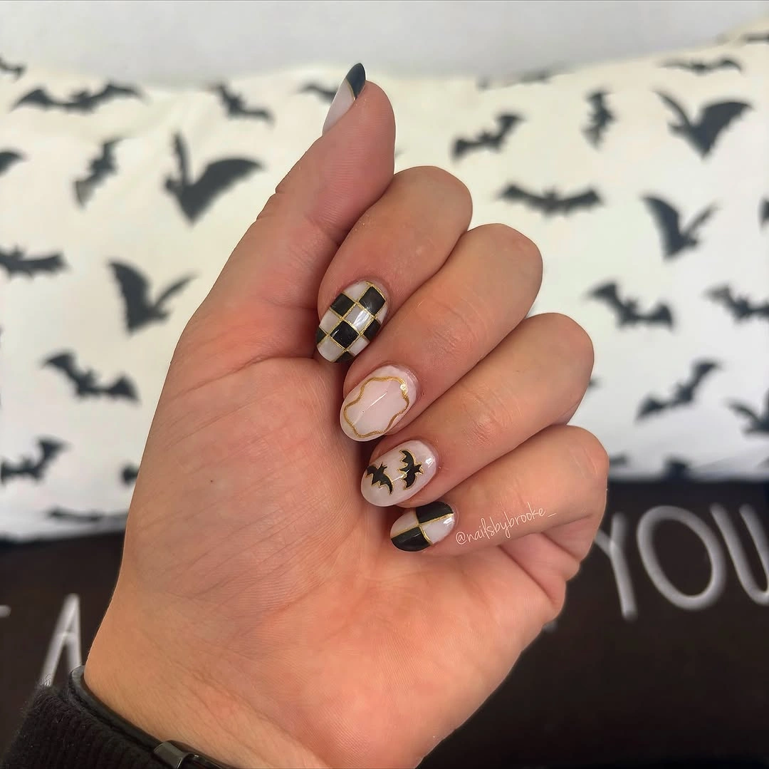 Short nude nails with brown checkerboard and abstract accents