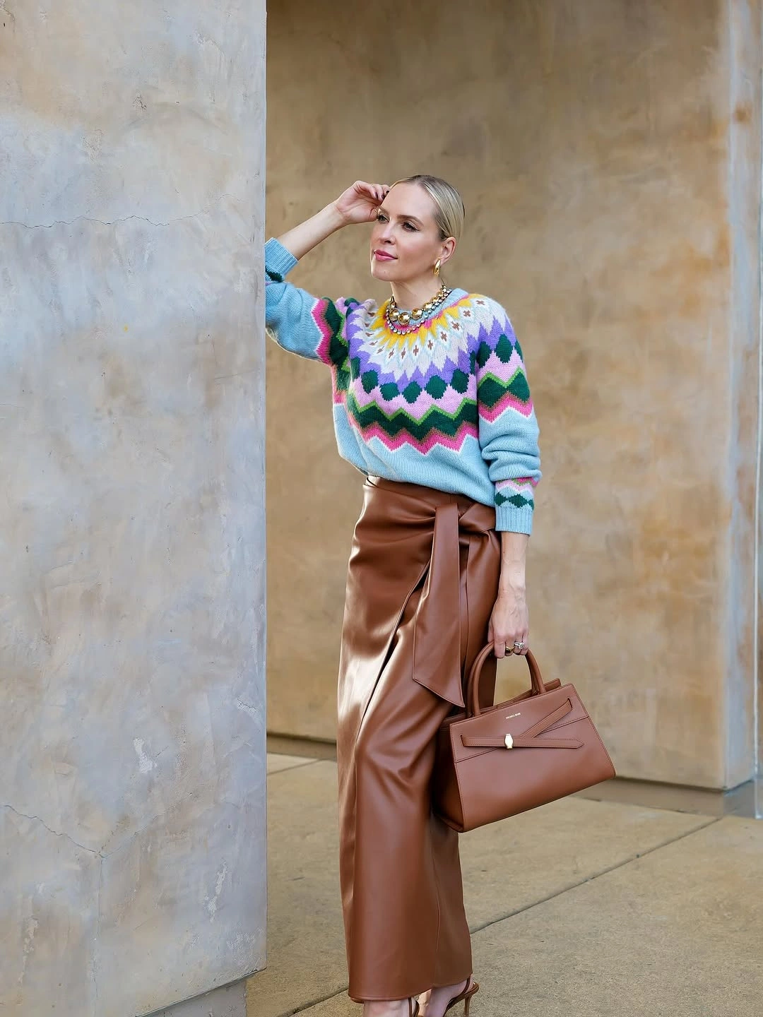 Colorful zigzag sweater with rust midi skirt and mauve bag