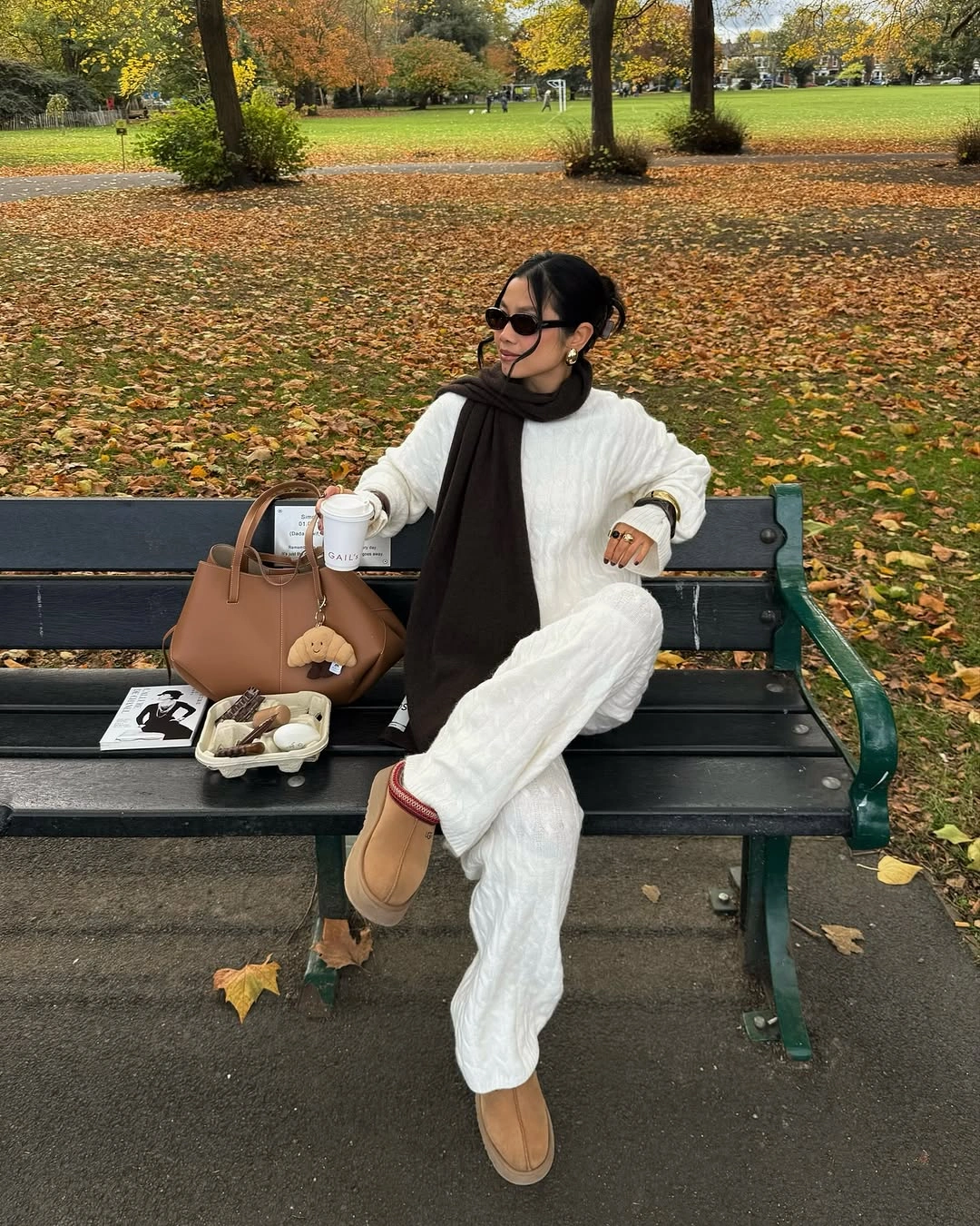 Cream cable knit wide trousers black scarf and tan boots