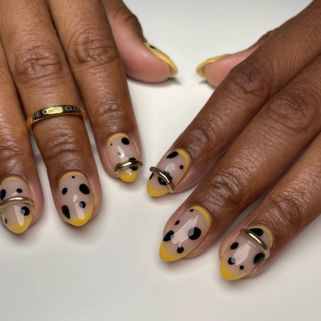 short rounded nails with mustard white black abstract color blocks and small black dots