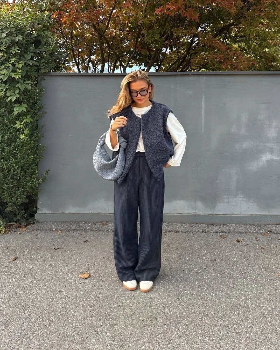 Charcoal sleeveless tailoring over white shirt and wide trousers
