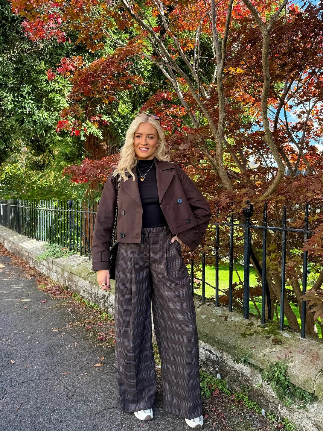 Brown cropped jacket styled with checked wide-leg trousers