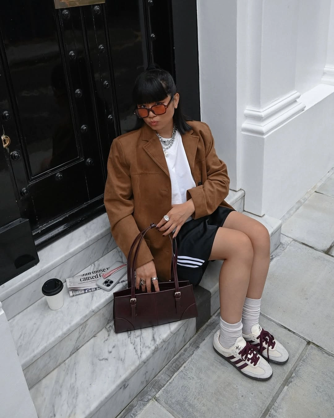 Camel blazer with black mini skirt white socks and burgundy sneakers