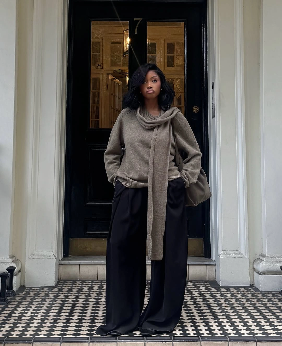 Oversized gray wrap styled with wide black trousers and structured bag