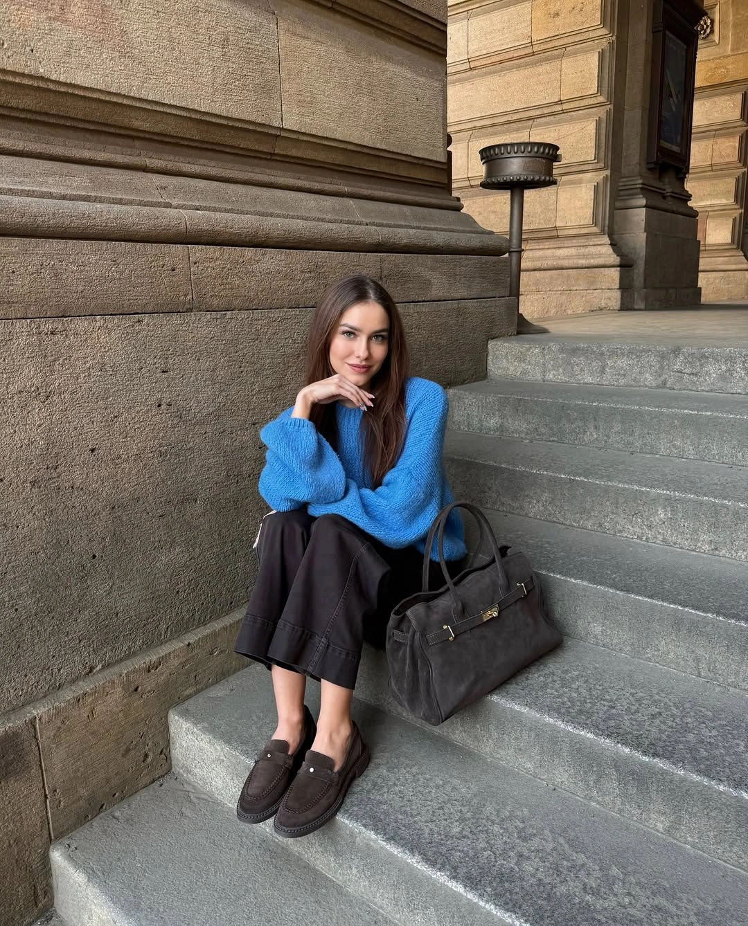 Cobalt sweater with dark skirt black loafers and large bag
