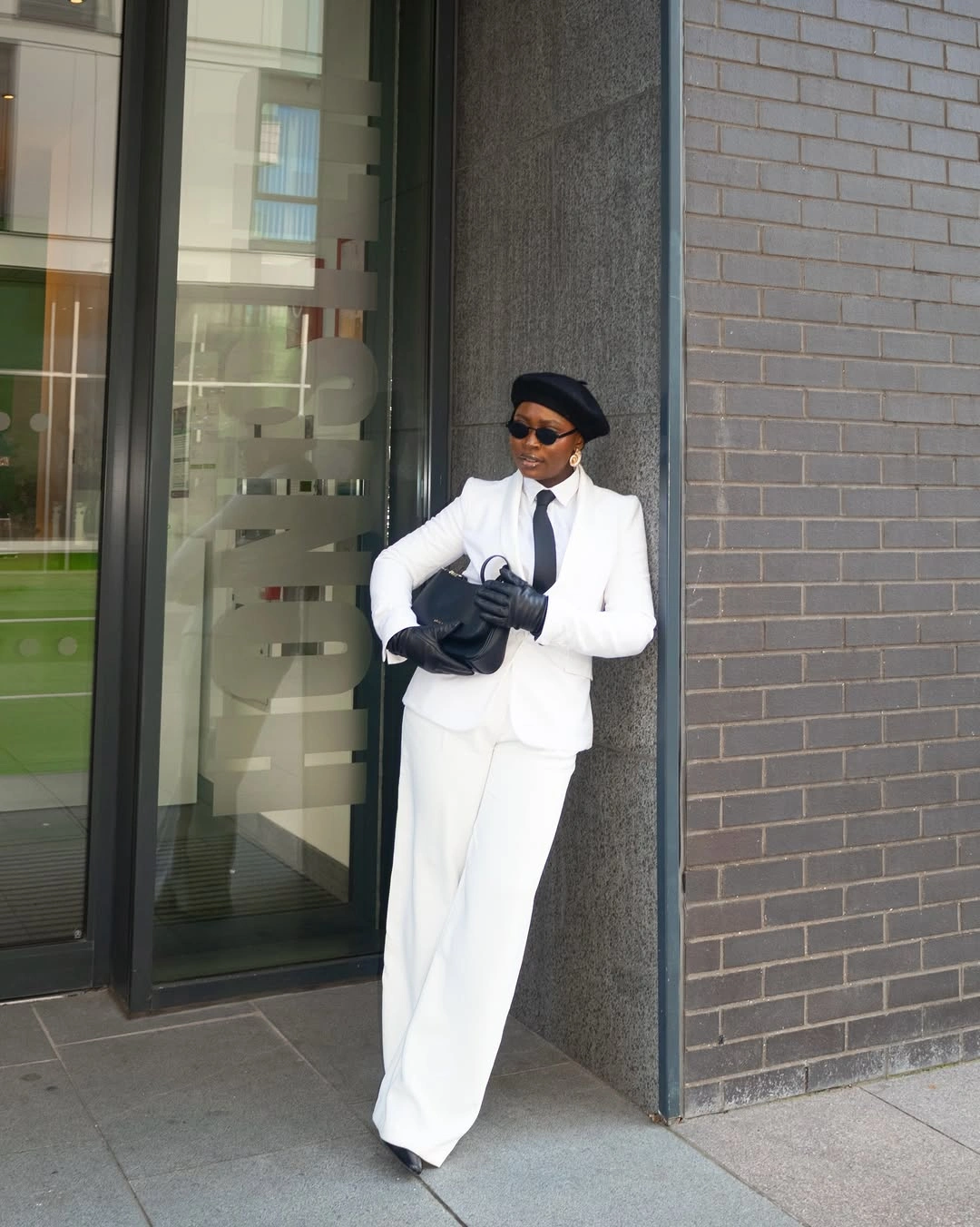 White suit with black base layer and dark accessories