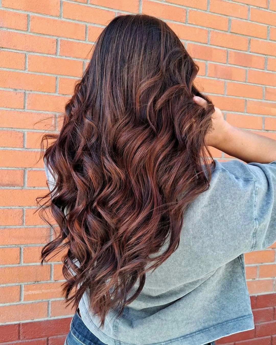 Long dark brown waves with subtle warm highlights