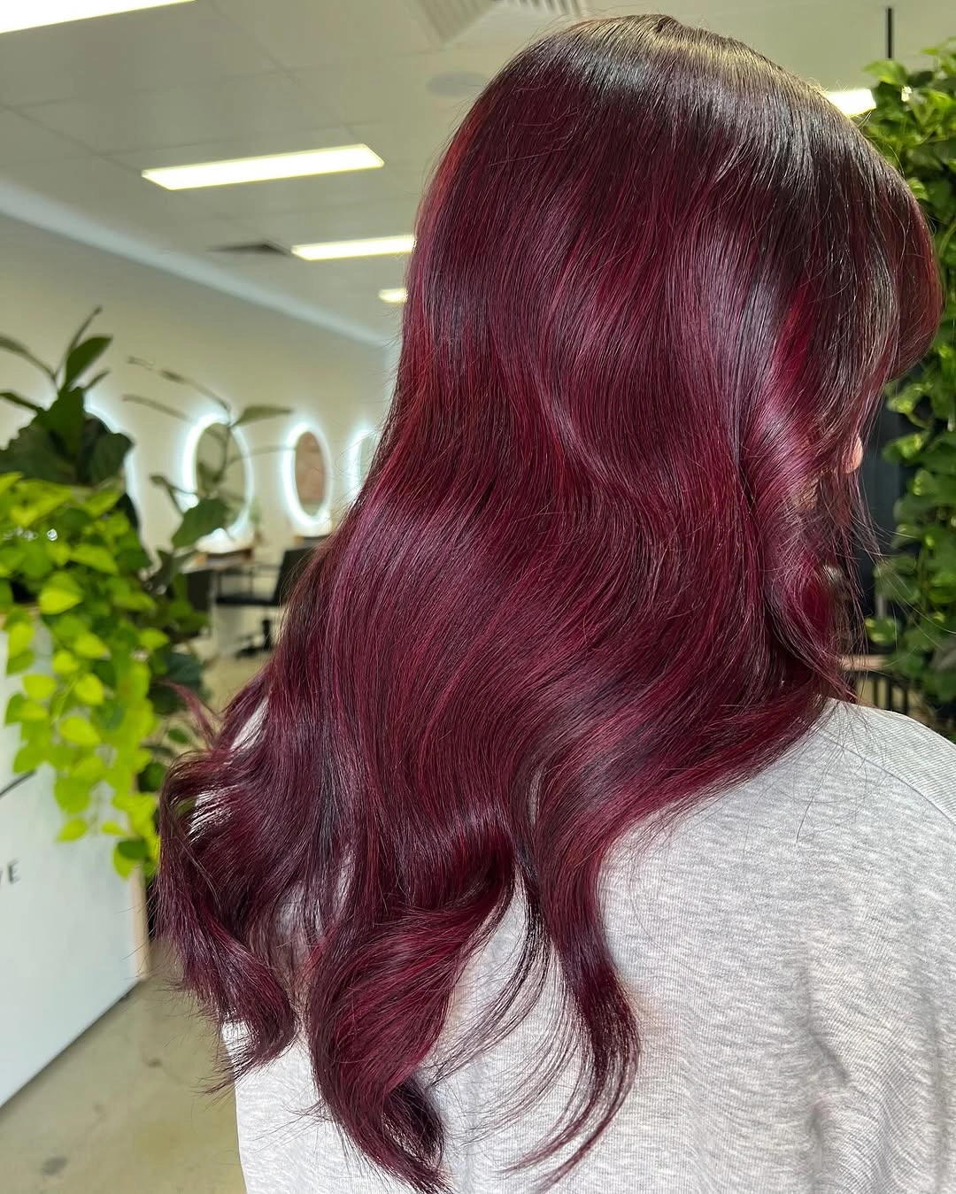 Long wine burgundy waves with a luminous finish