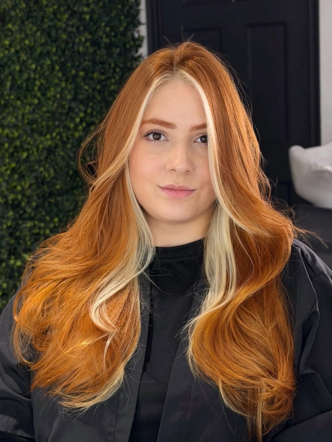 Long copper hair with lighter face framing and soft waves