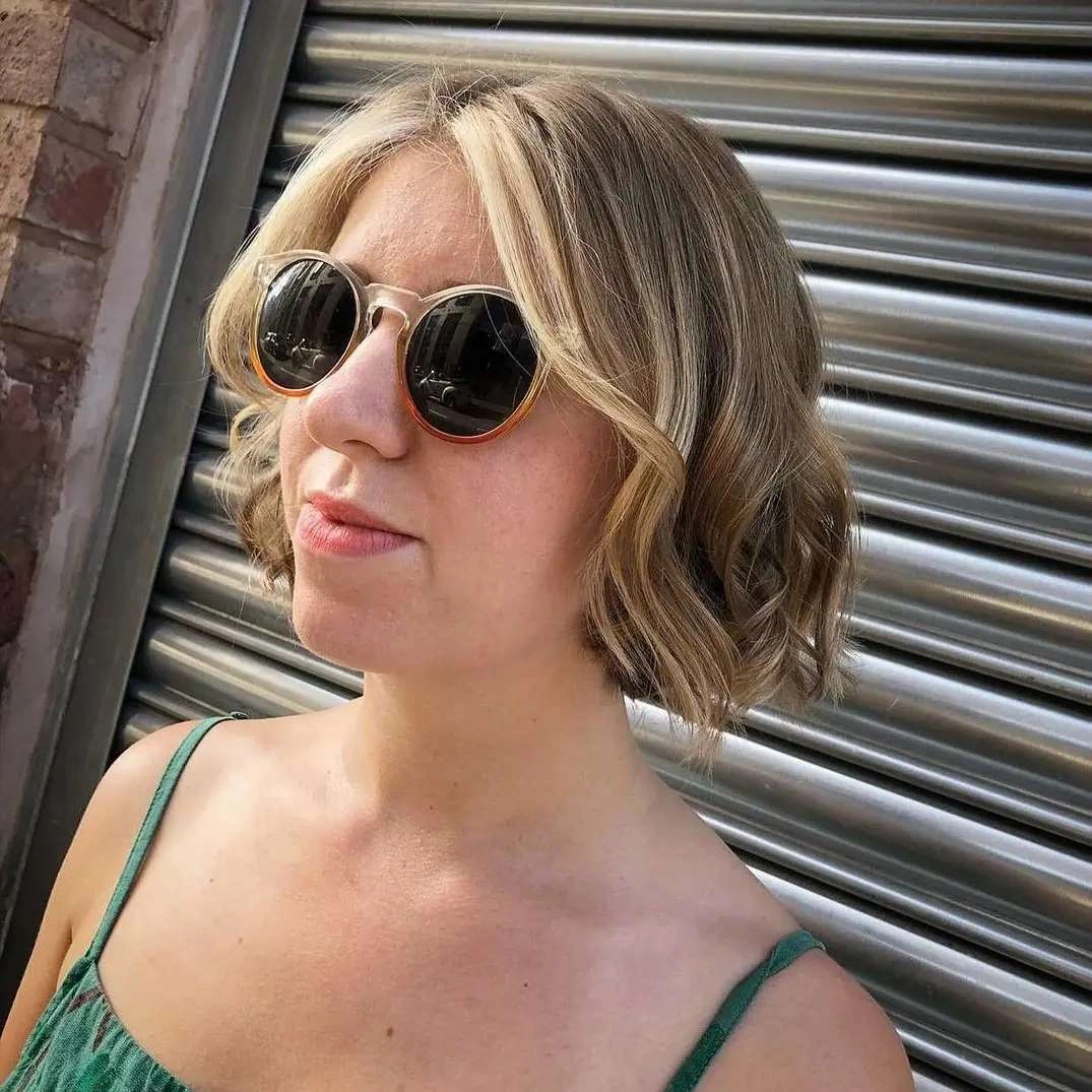 Short blonde side-parted bob with rounded ends