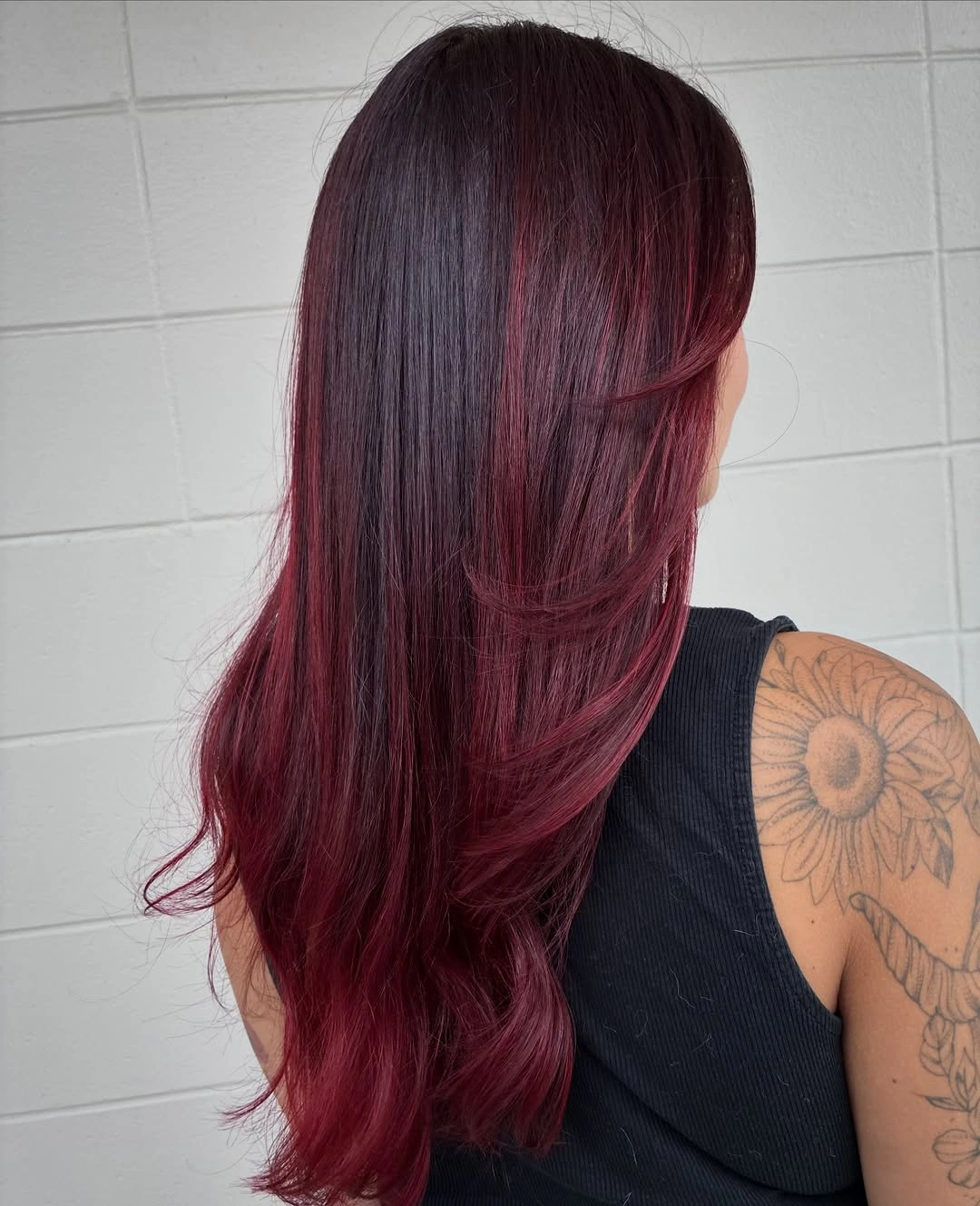 Long deep burgundy hair with a smooth side-swept fall