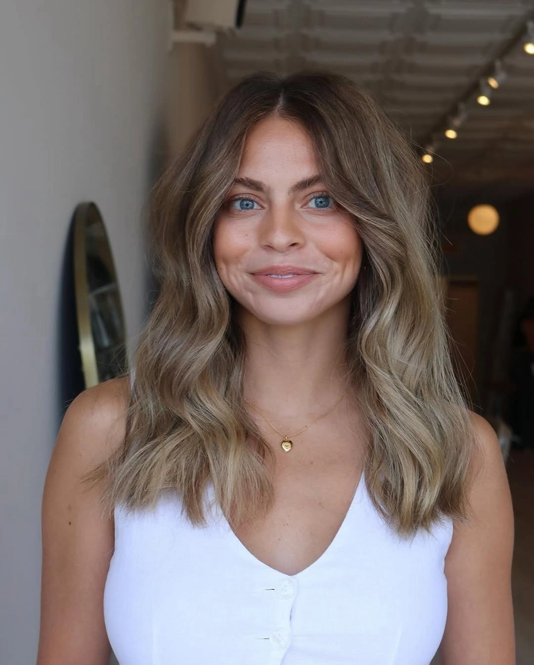 Shoulder length bronde waves with centered part