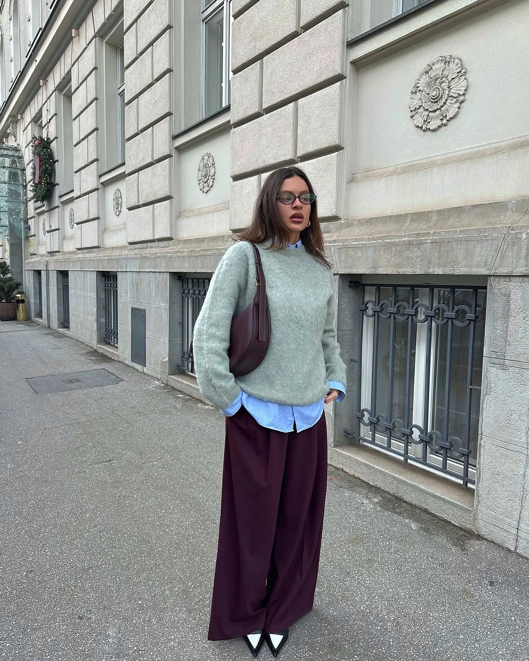 Mint sweater over blue shirt with deep wine trousers