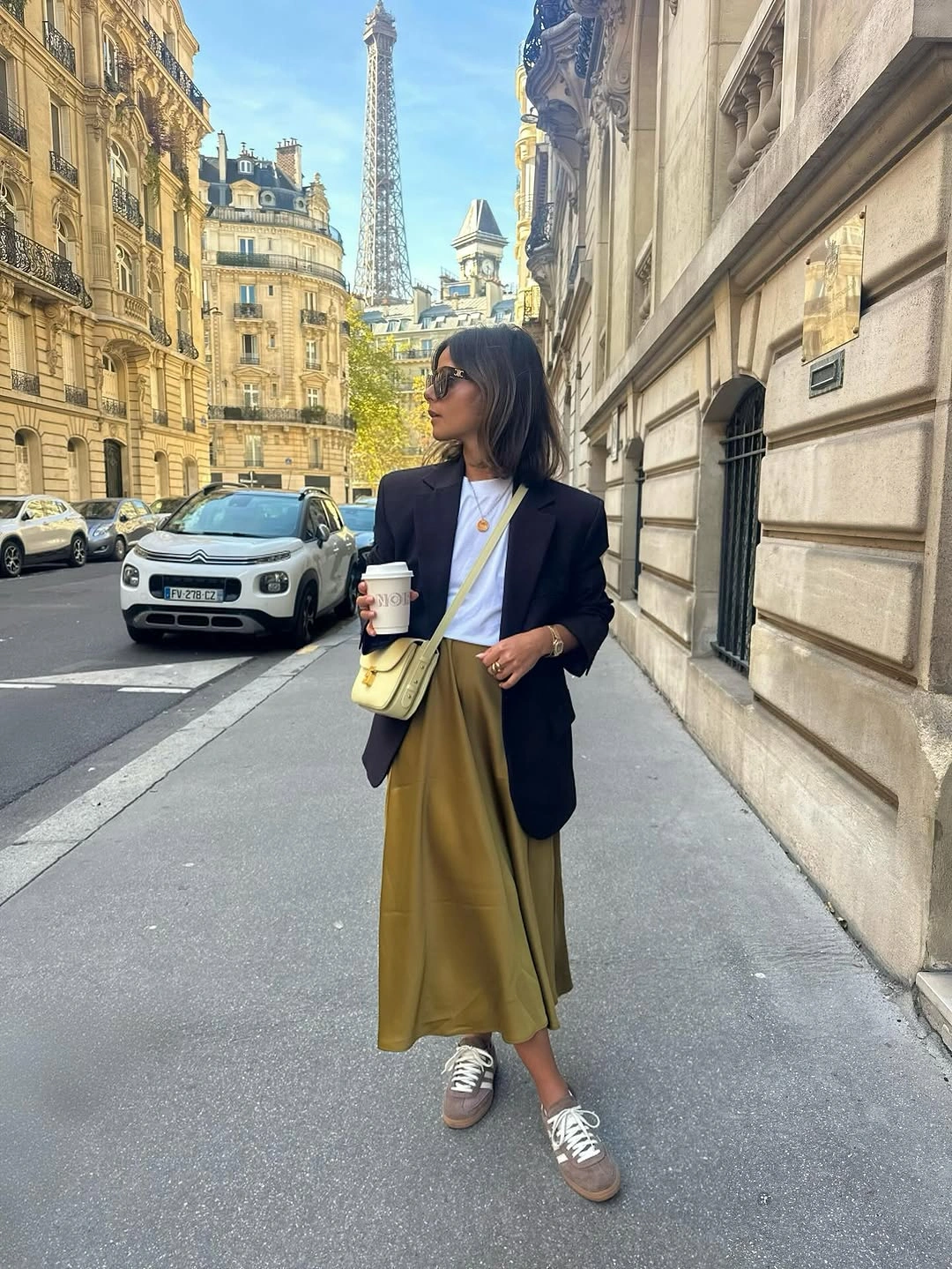 Navy blazer with olive midi skirt and casual sneakers