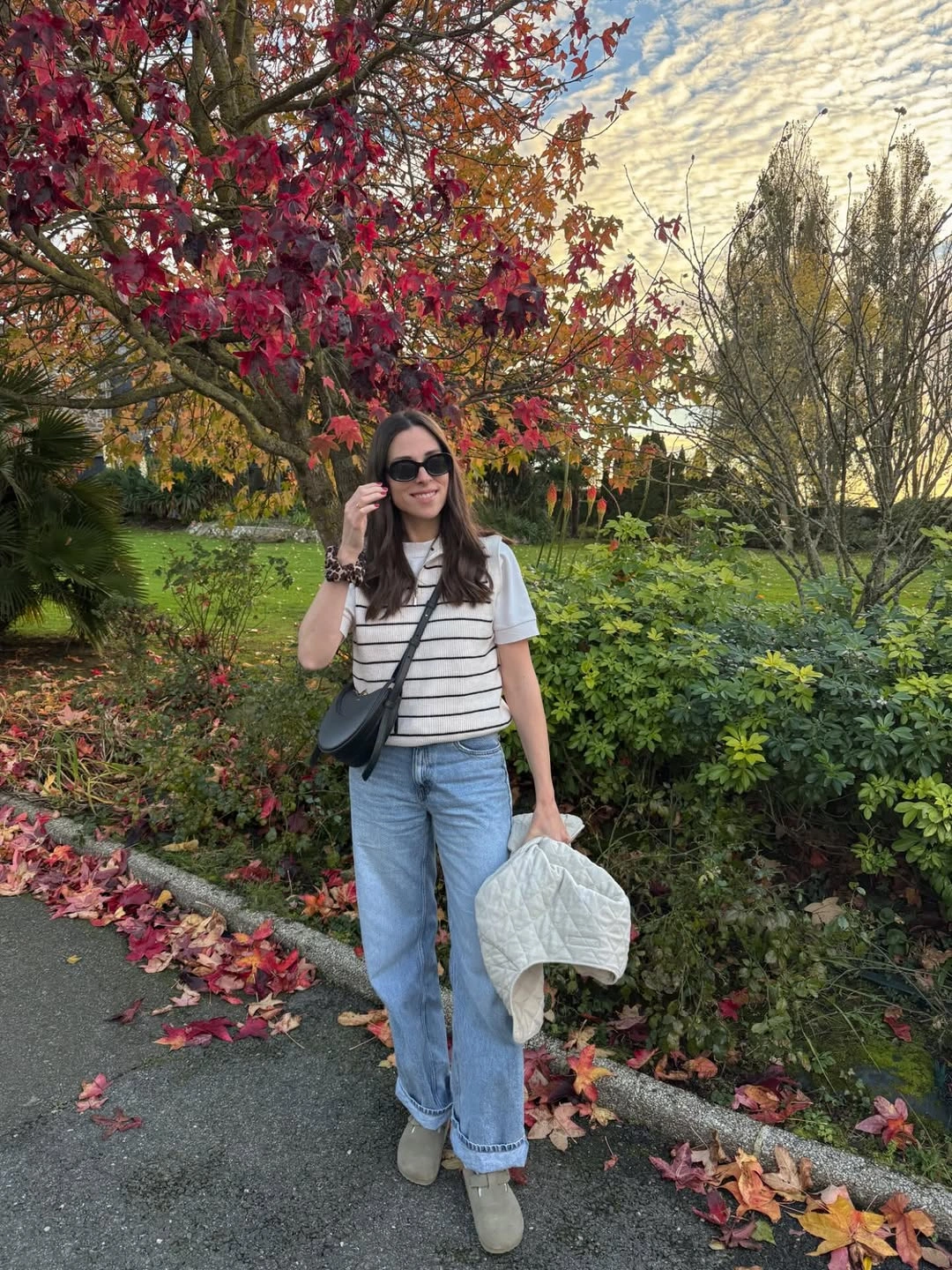 Striped tee with light blue jeans and layered everyday bags