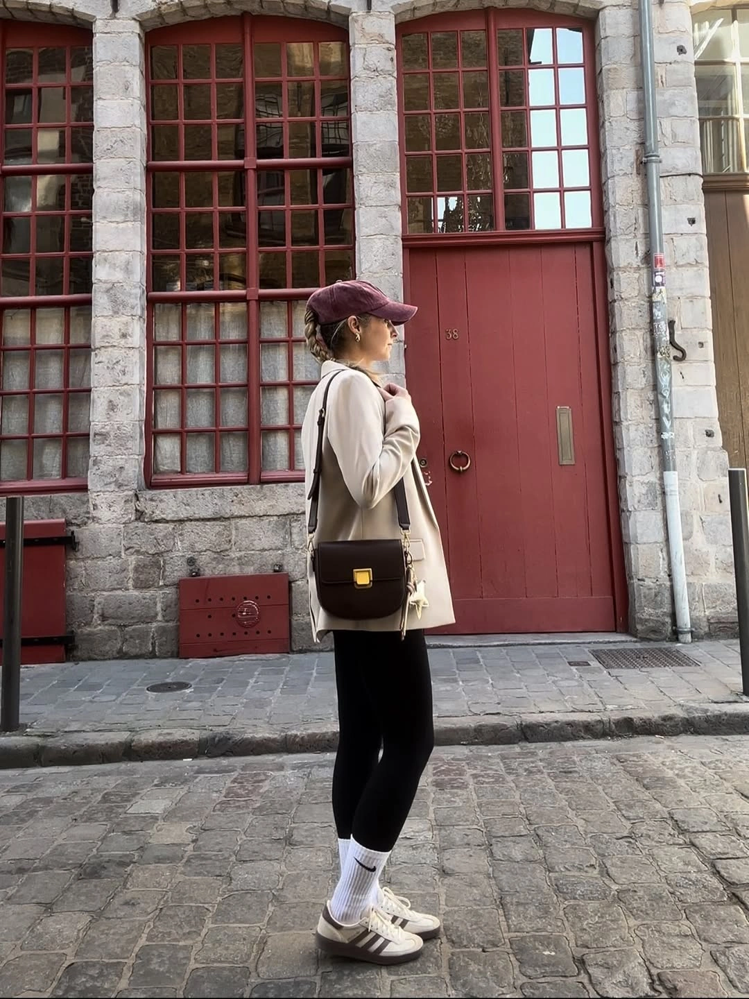 Light jacket with black leggings purple cap and white socks