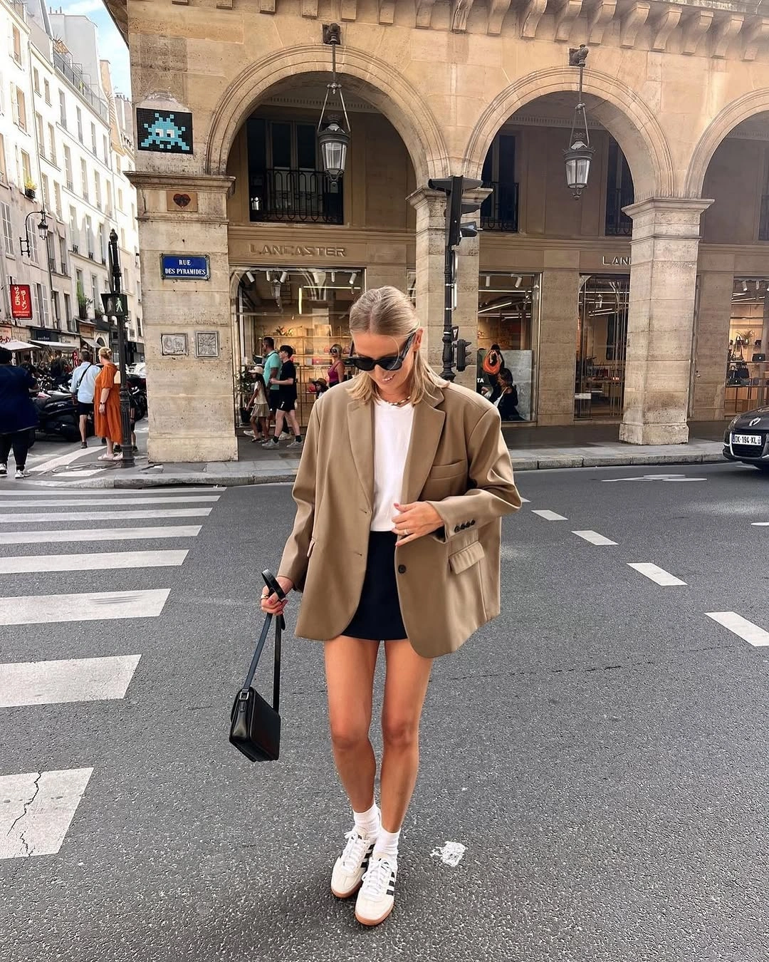 Camel blazer over black shorts with white sneakers