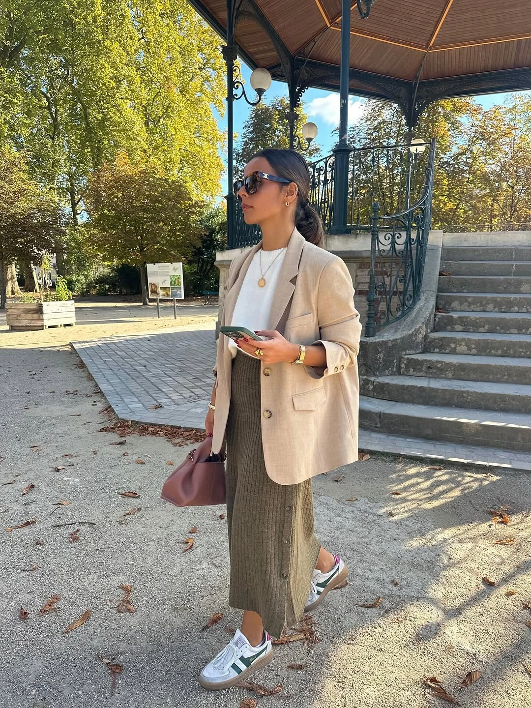 Cream blazer with long muted skirt and pale sneakers