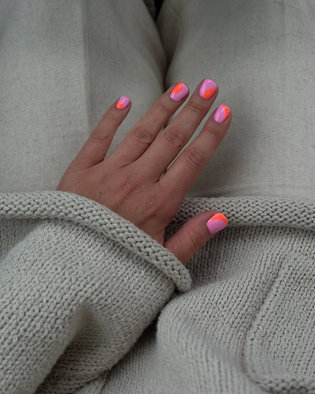 Short nude square nails with bright neon pink French tips