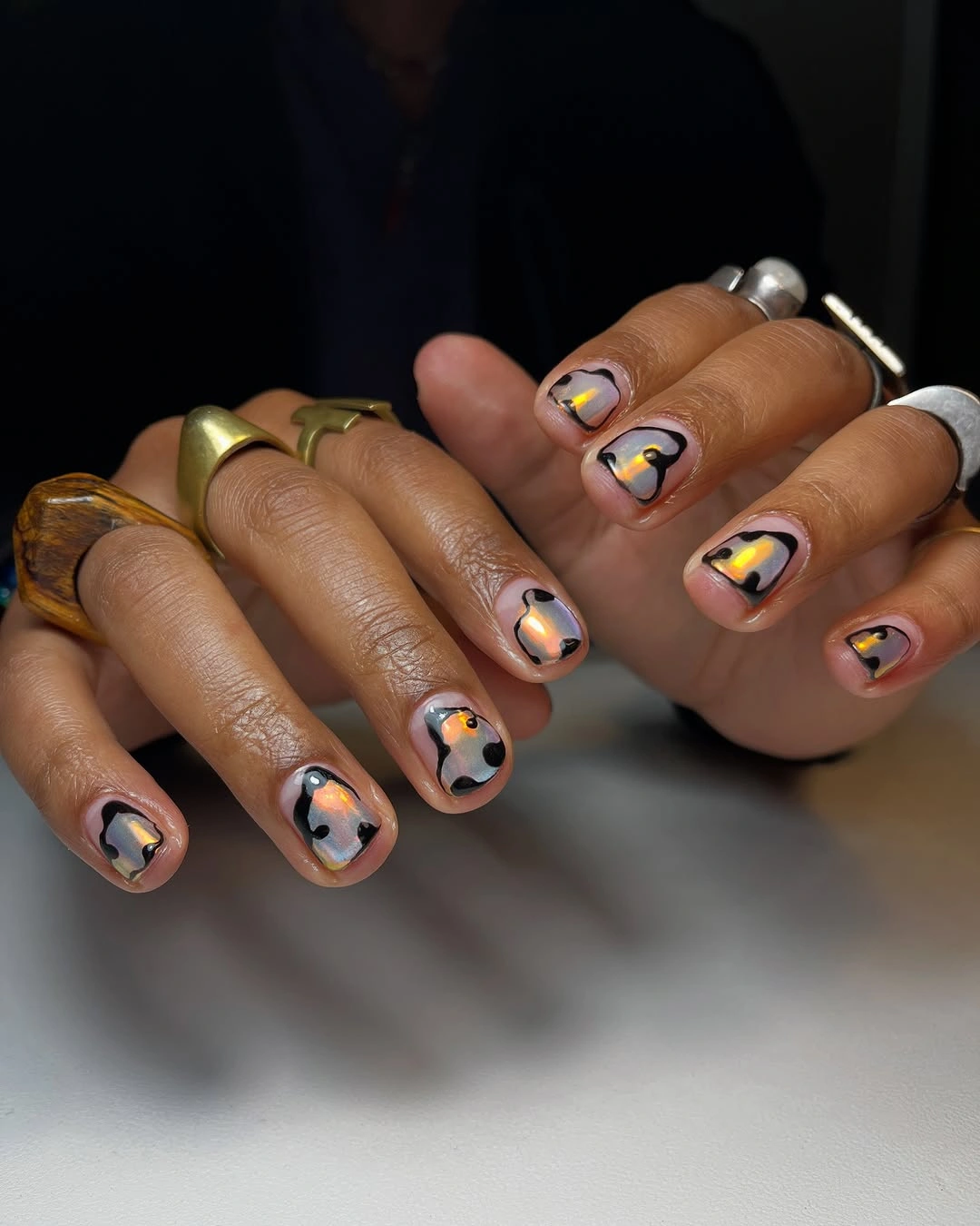 Short nude nails with black outlined warm abstract loops