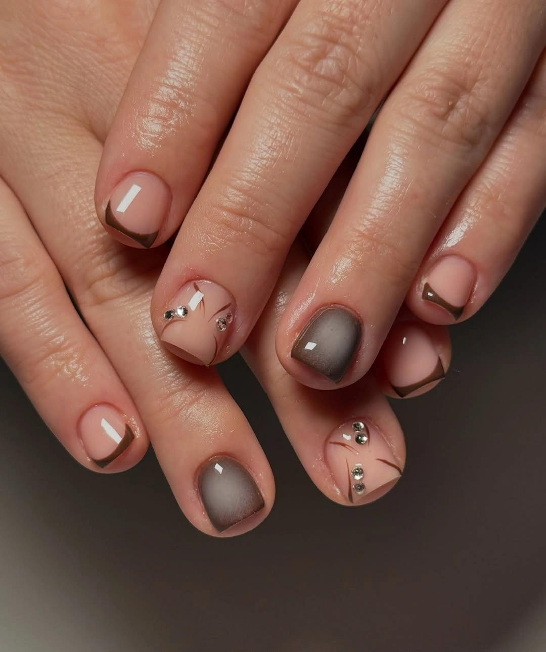 Short nude nails with brown contours smoky gray and tiny gems