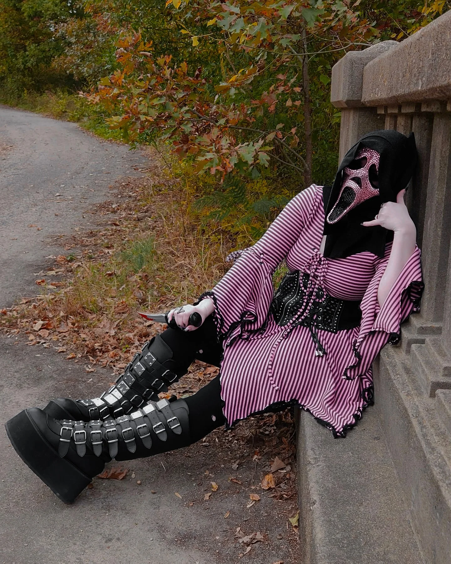 Ghostface Scream costume with purple stripes, black hood, mask, and tall boots