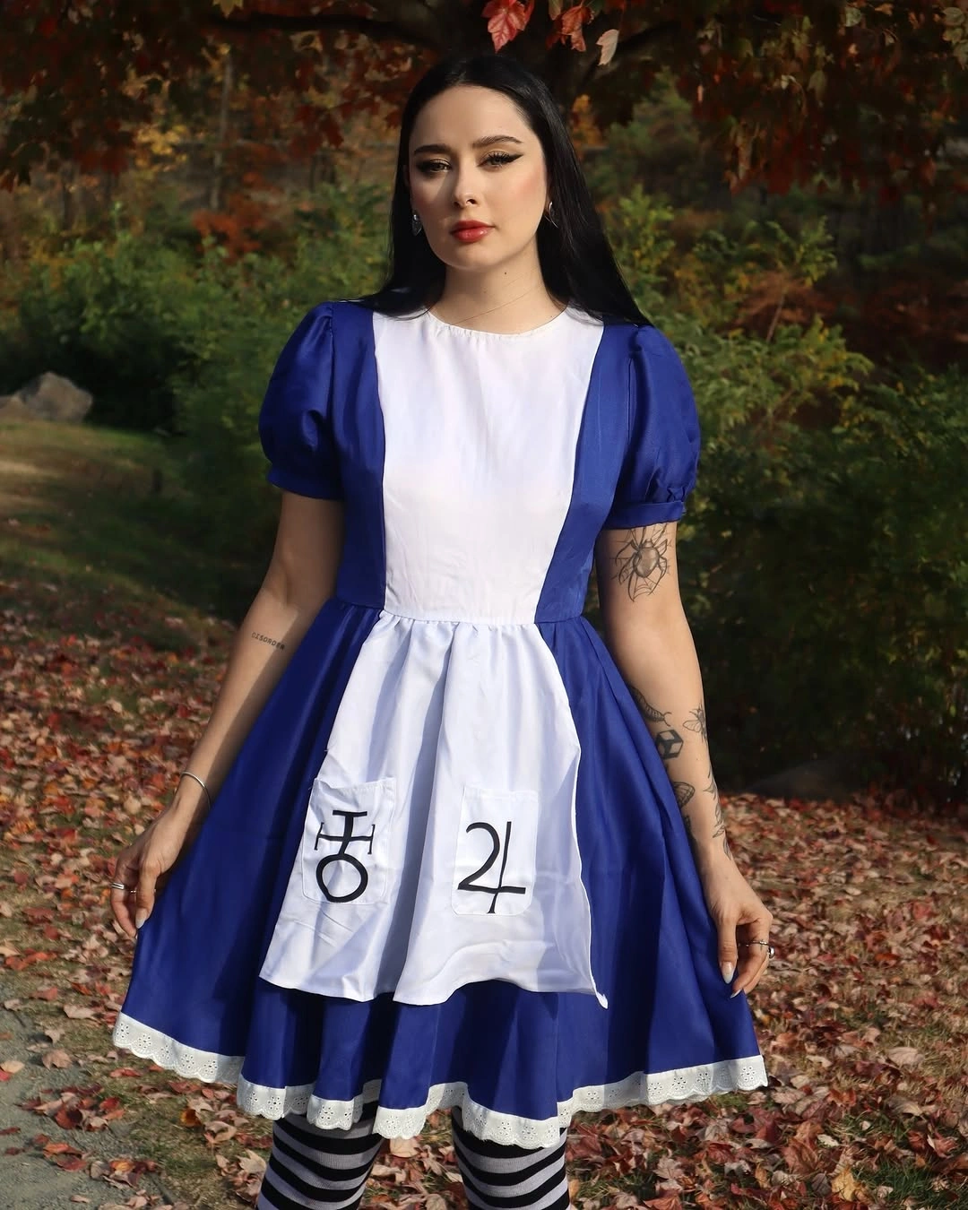 Alice in Wonderland costume with blue dress, white apron, and striped tights