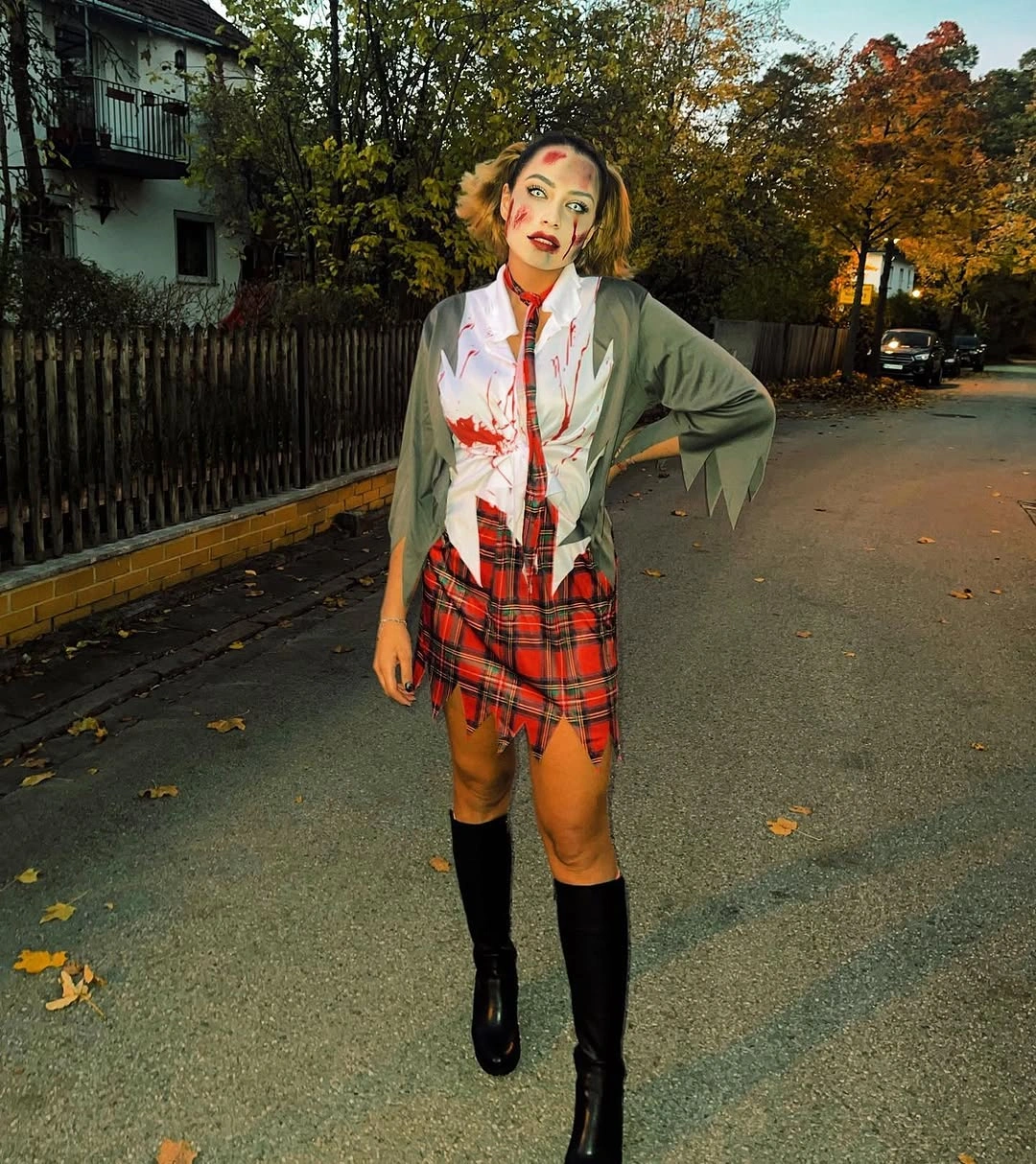 Zombie schoolgirl Halloween costume with gray blazer, plaid skirt, and pale makeup