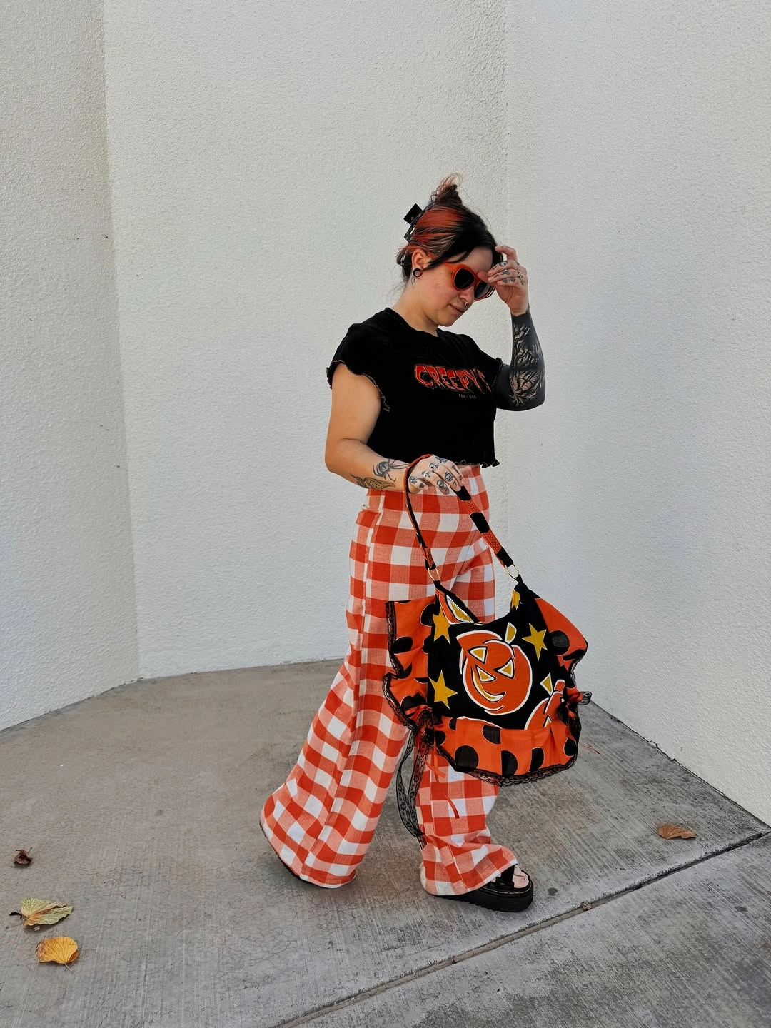 Pumpkin patch Halloween character in orange gingham trousers and black top