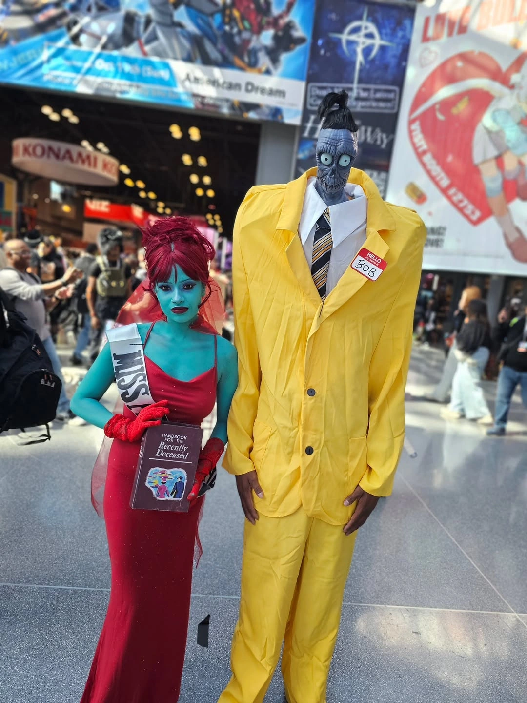 Corpse Bride-inspired blue-faced couple in burgundy dress and yellow suit