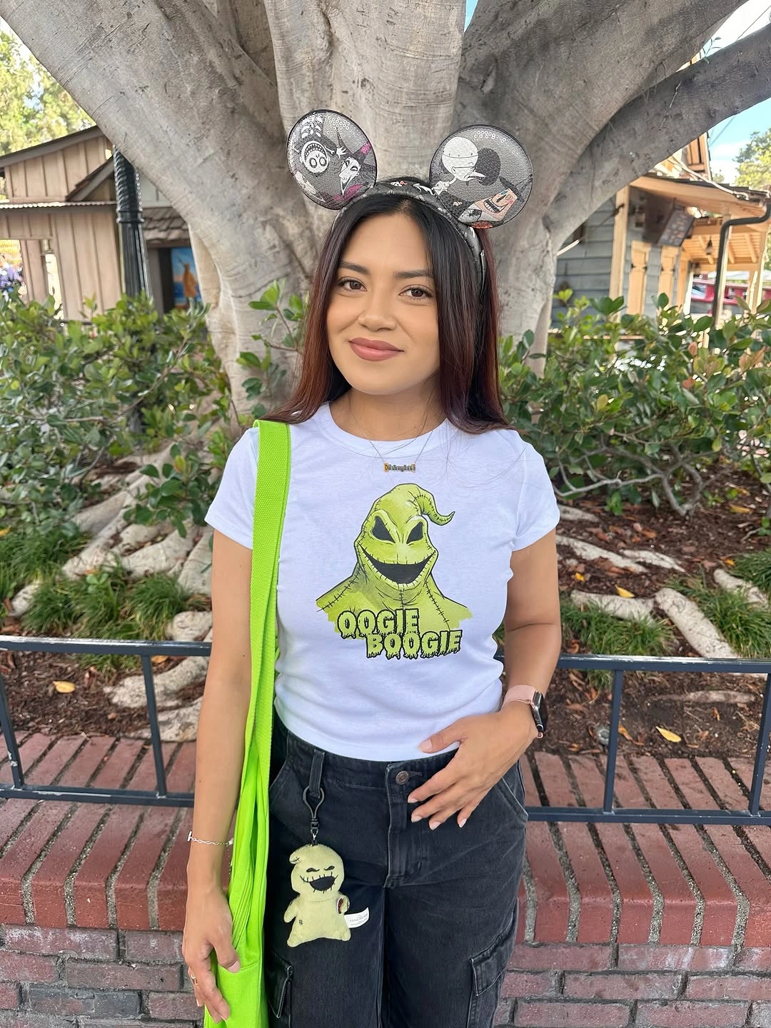 Oogie Boogie costume with graphic shirt, dark jeans, lime bag, and ears