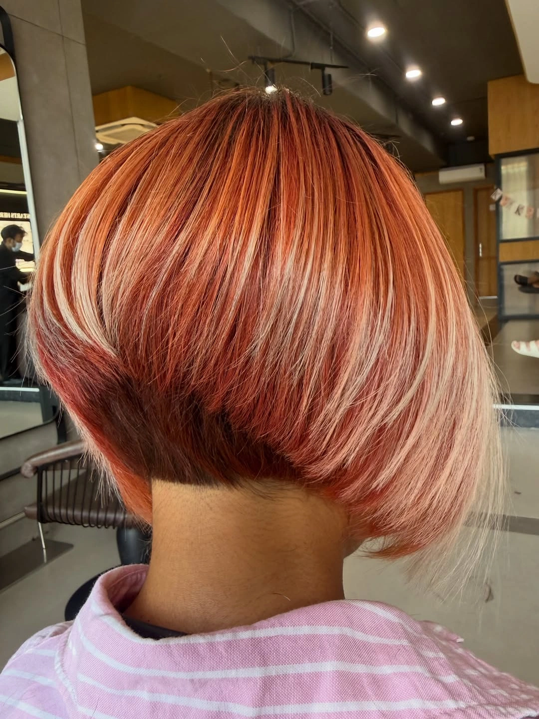 Copper red stacked A-line bob with blonde front section