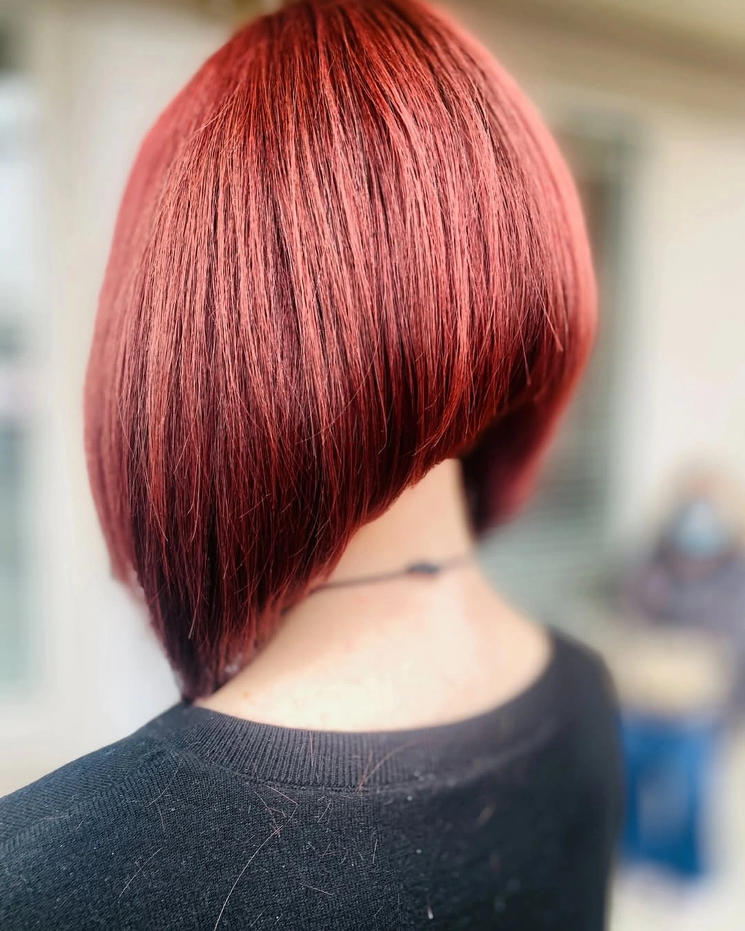Red stacked A-line bob with rounded back and tapered nape