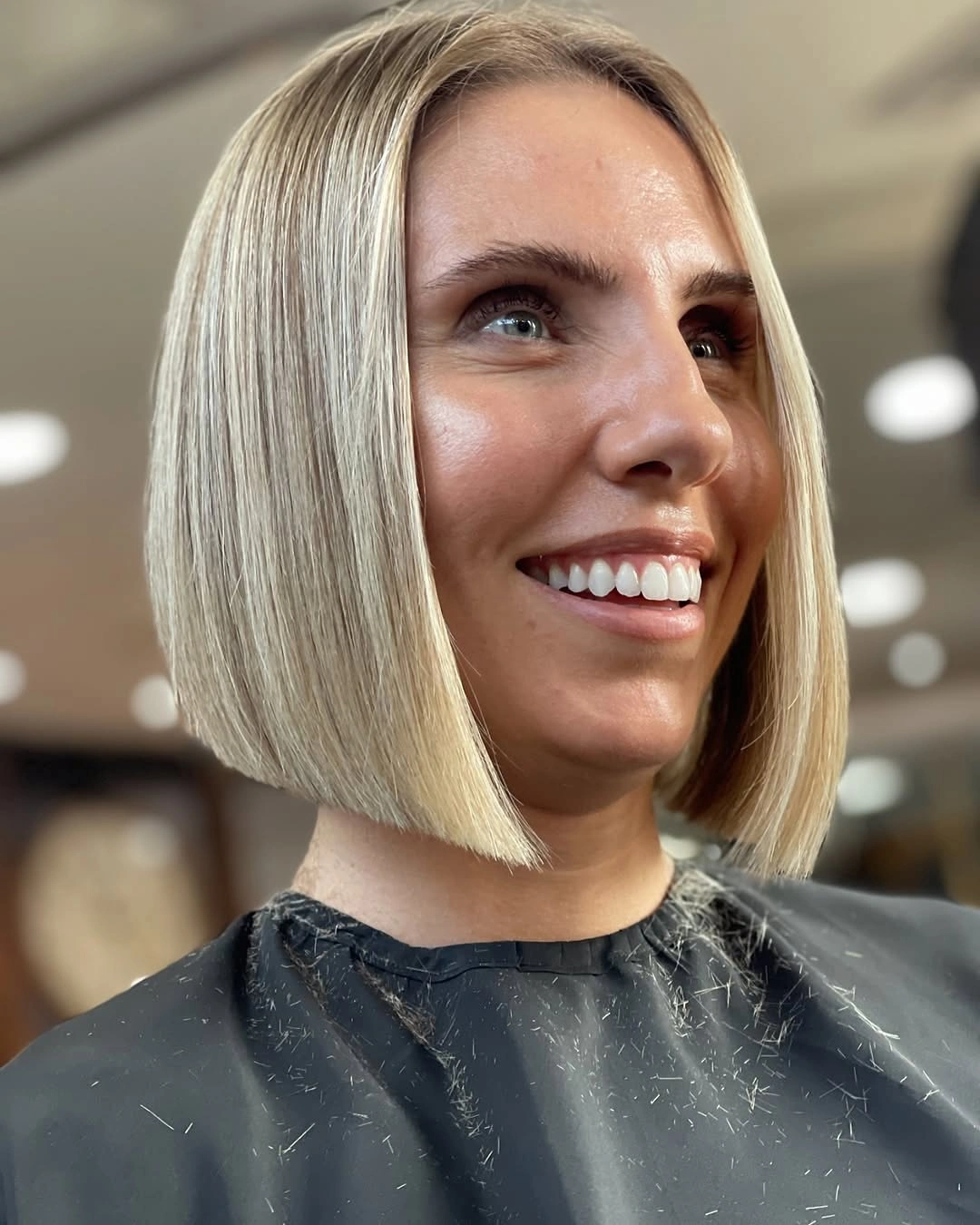 Pale blonde blunt bob with center part and chin-length ends