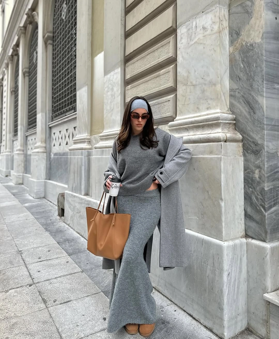 Gray sweater, long gray skirt, gray coat, tan tote and shoes