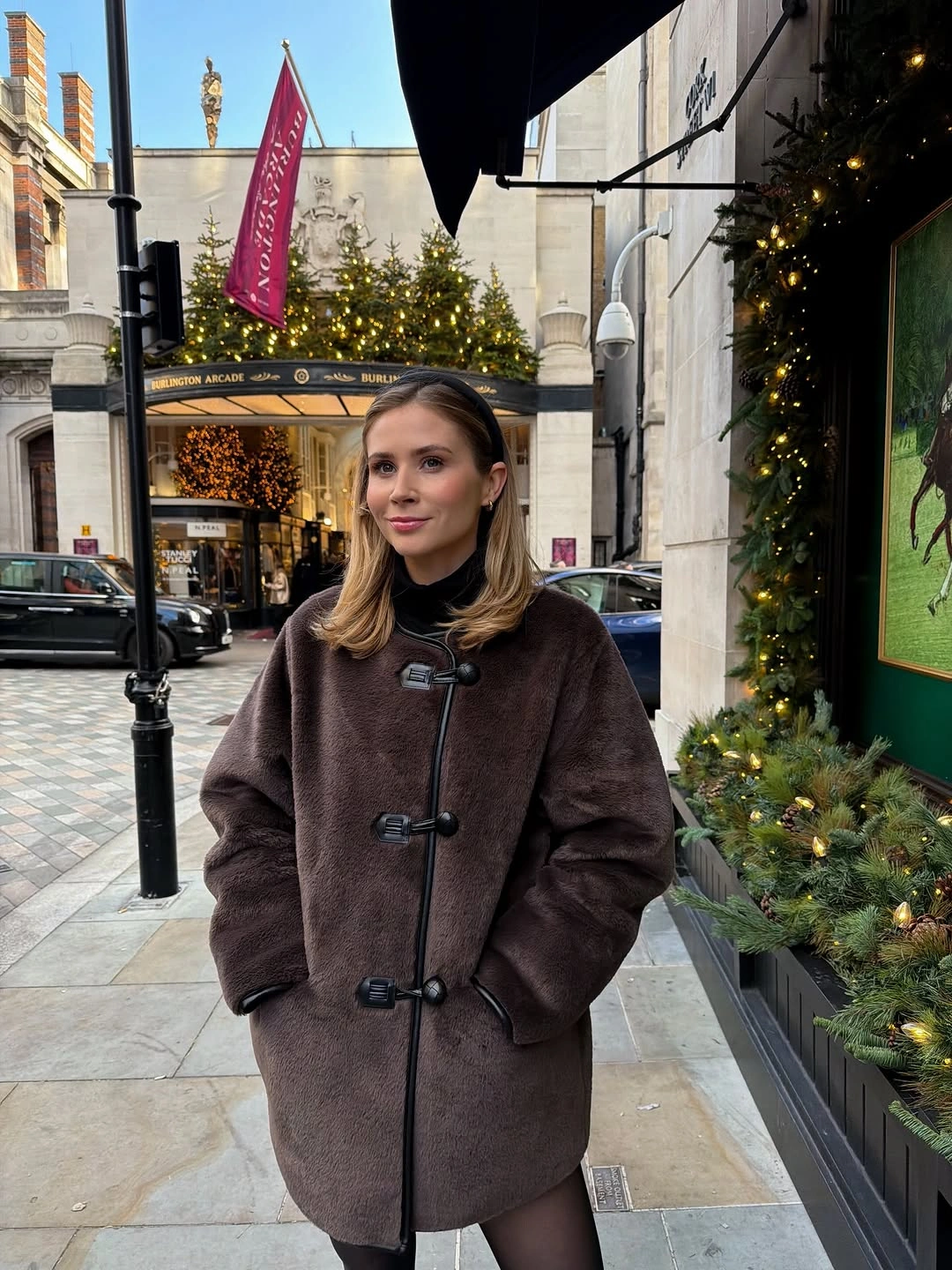 Dark brown toggle coat over black high-neck outfit