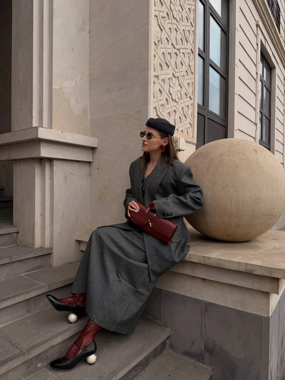 Oversized gray blazer and long skirt with burgundy bag and patterned hosiery