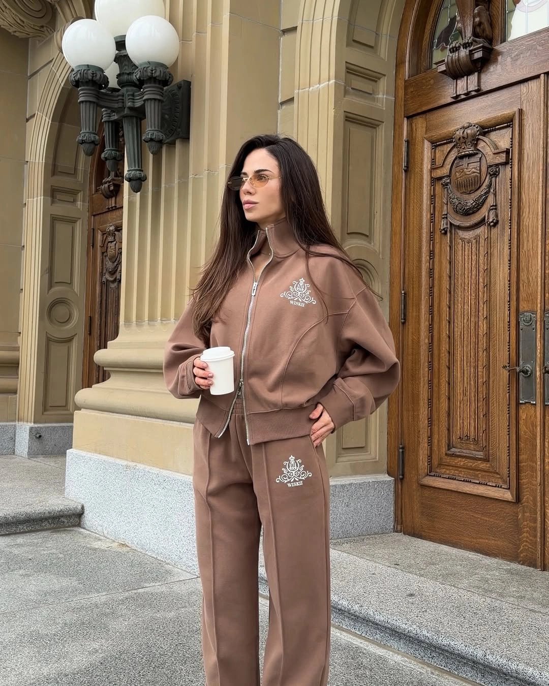 Coordinated brown zip-front top and wide-leg pants with pale graphics