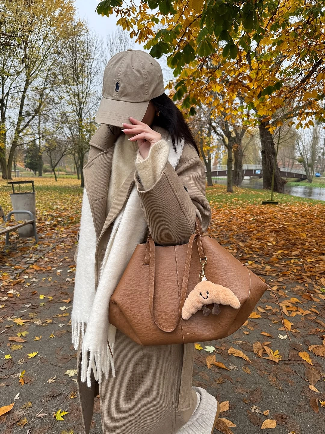 Taupe outer layer, cream scarf, beige cap, tan tote, and pale hem