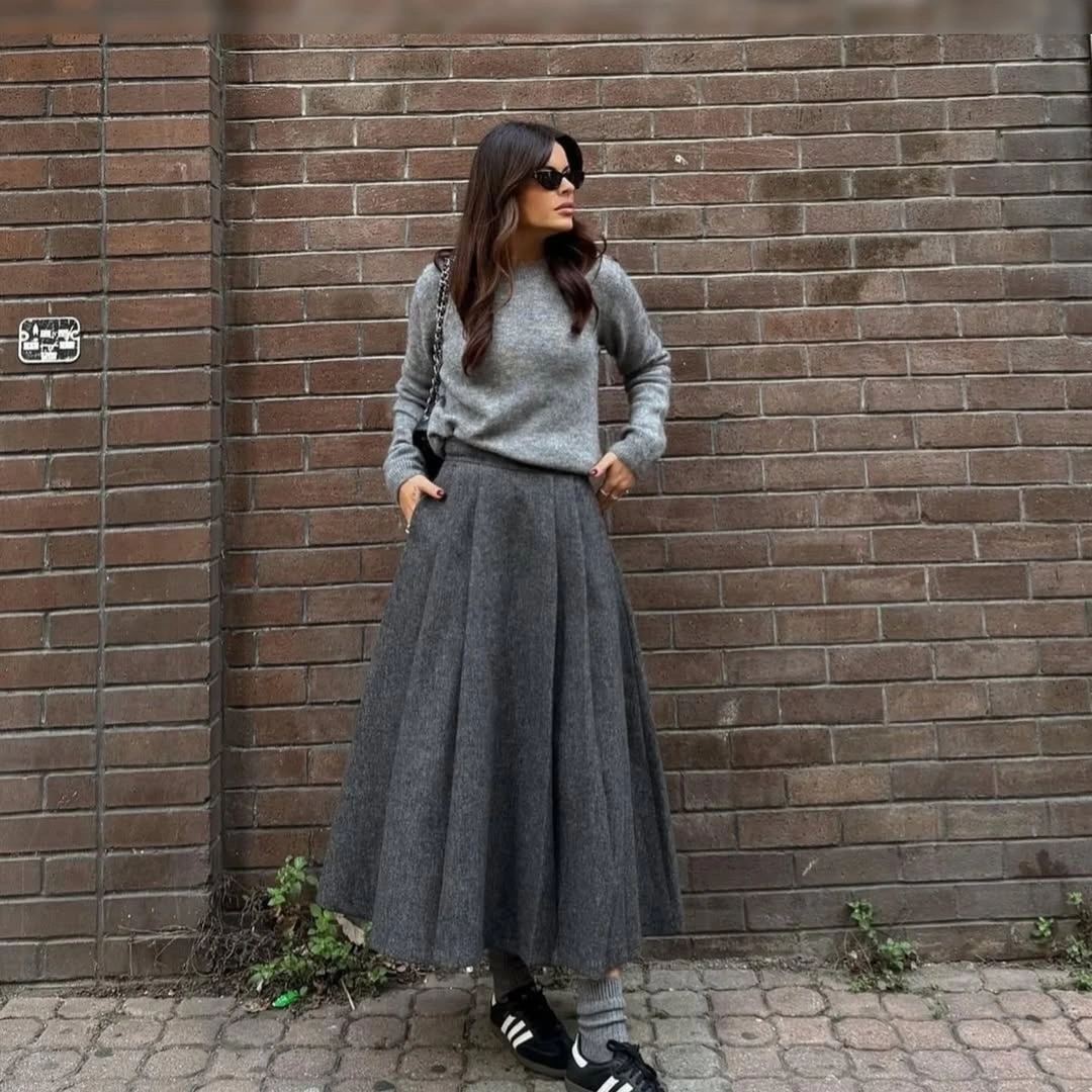 Gray sweater with full charcoal skirt, layered socks, and black sneakers