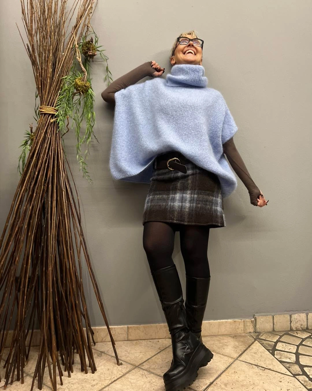 Pale-blue cowl knit with plaid mini, tights, and tall black boots