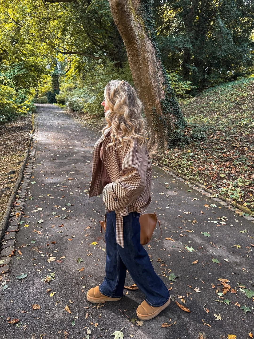 Patterned tan-brown jacket with dark wide jeans and tan platform footwear