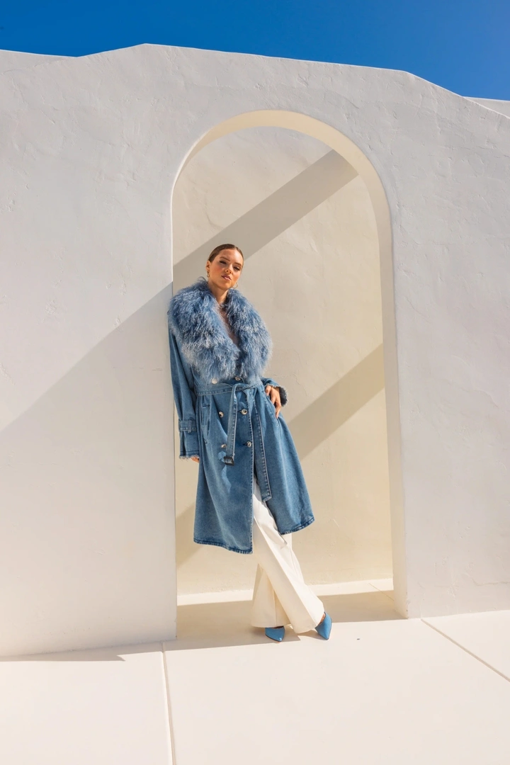 Long blue belted coat with white trousers and pointed blue heels