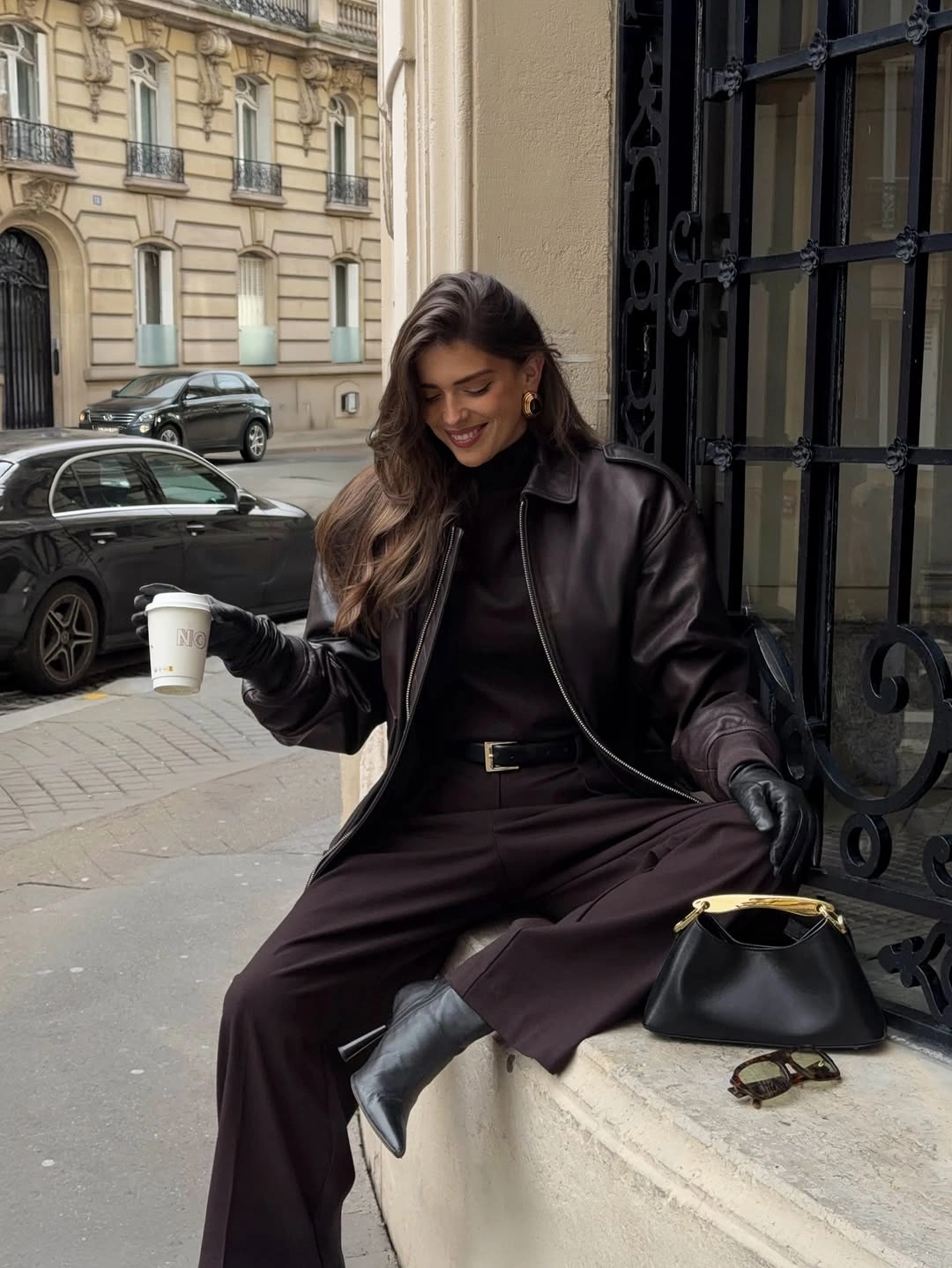 Brown leather-look jacket with matching wide trousers and black handbag