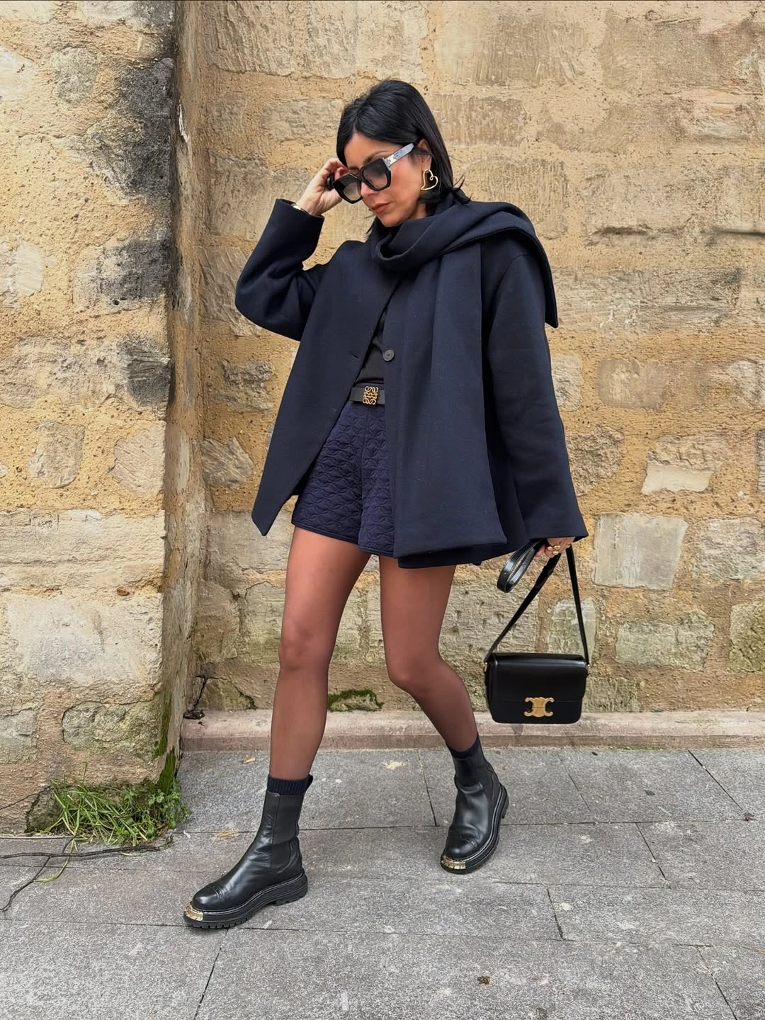 Oversized navy blazer black skirt tights ankle boots and small bag